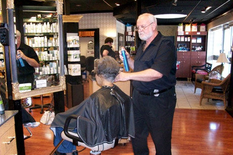 Owner Jack cutting a client's hair at J.R.'s